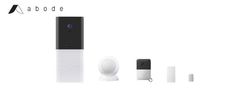 Shows a line-up of sample equipment found in an Abode home security system: the Iota gateway, motion sensor, key fob, contact sensor, and mini contact sensor.