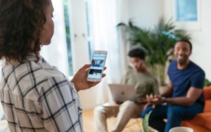 Mother looking at security system app with family