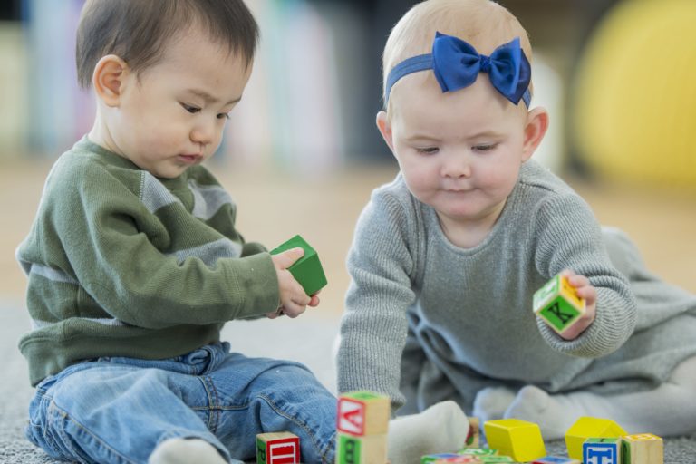 two babies playing in daycare