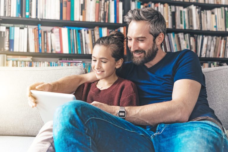 father and daughter using a computer