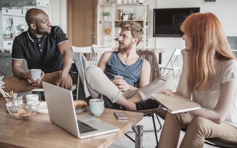 African american male, white male, red-haired female talking at table