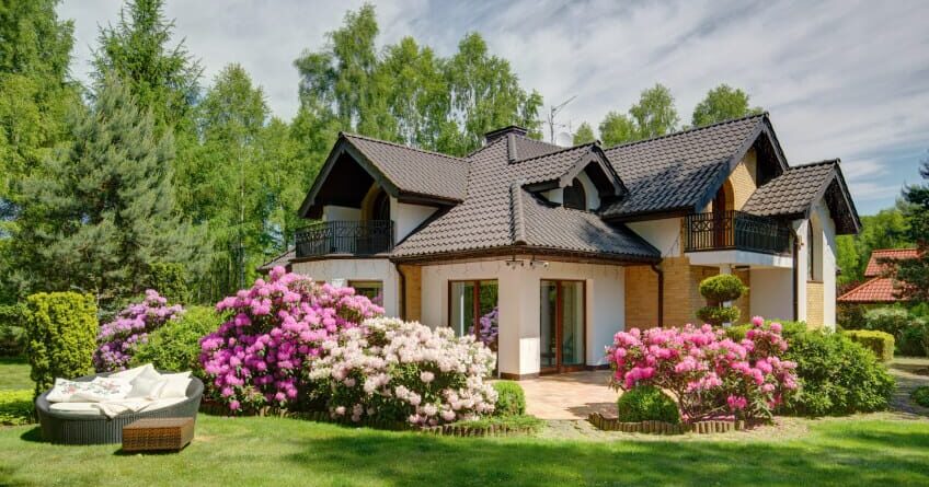 residential house with lawn and flowers