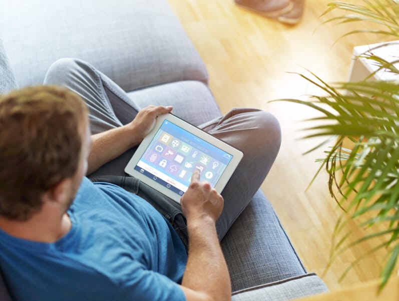 man on couch with tablet