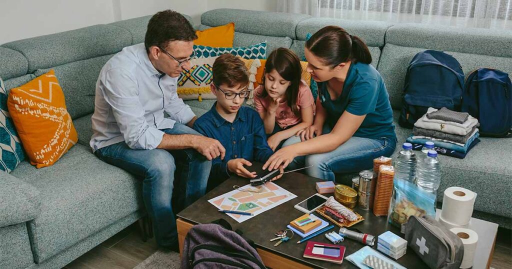 family sitting in living room preparing emergency plan