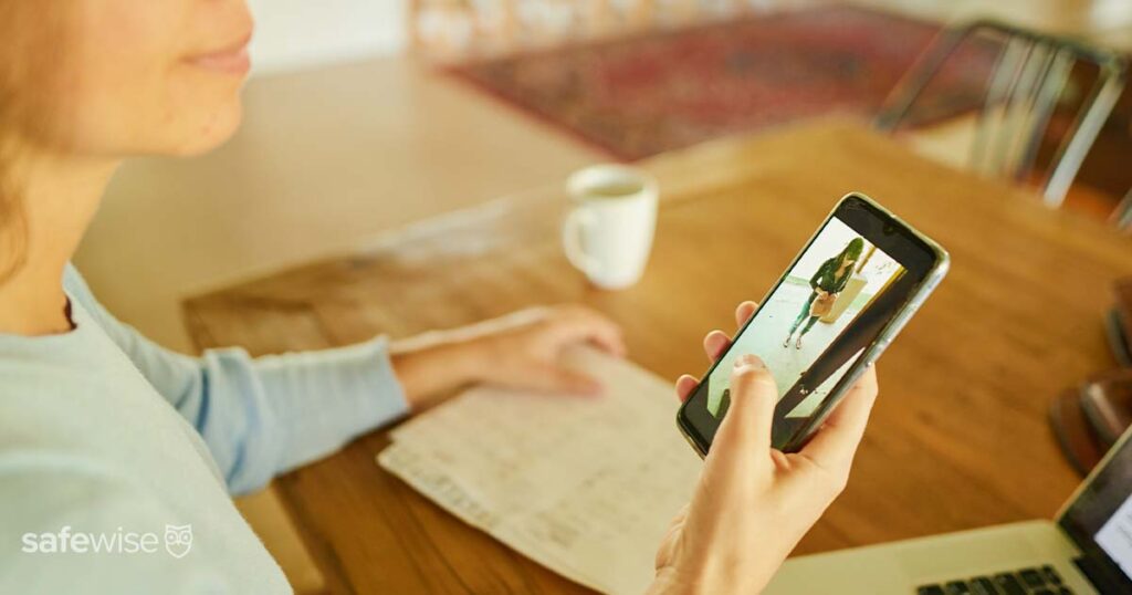 woman checking her video doorbell from her phone