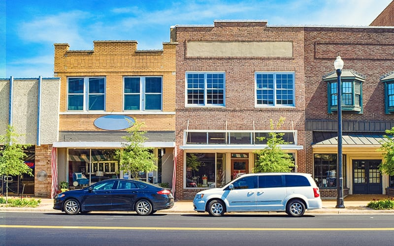 two cars parked on business street