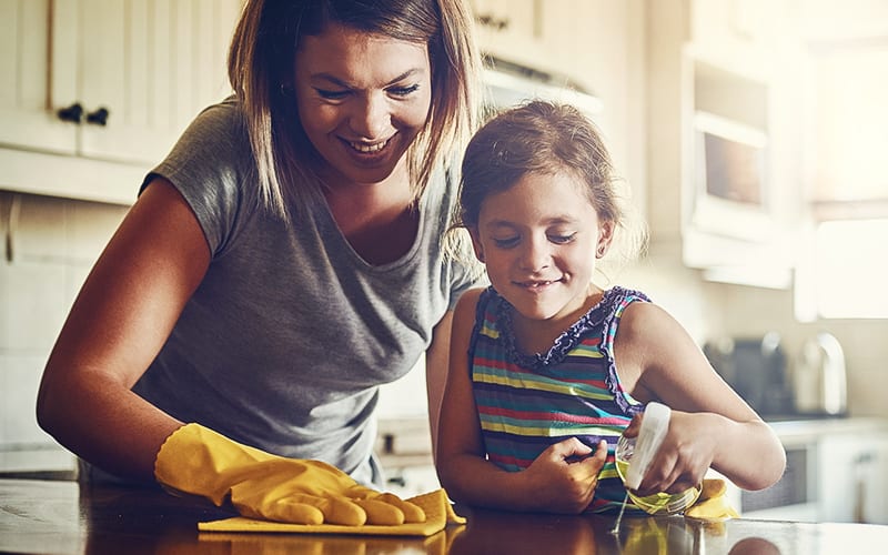 mom and daughter cleaning kitchen