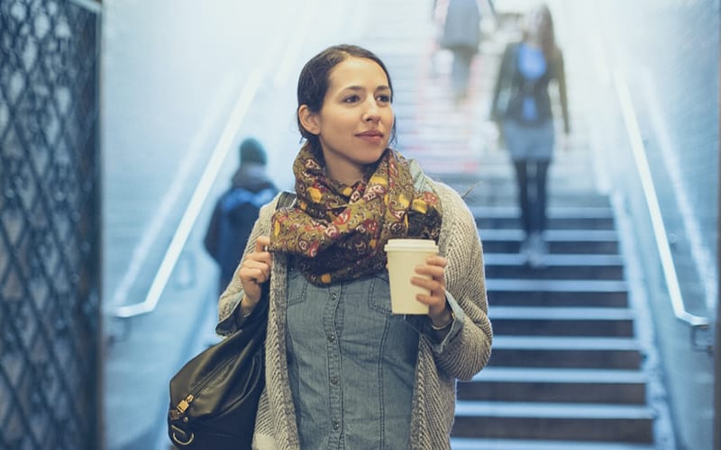 woman walking into train station