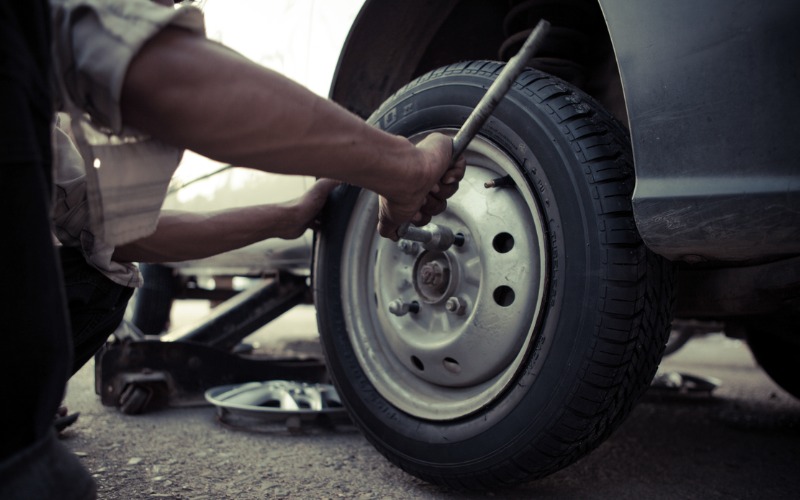 using car jack to change a tire