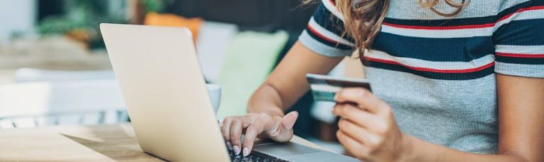 woman at computer with credit card out