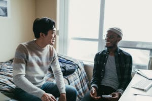 photo of two friends in dorm room