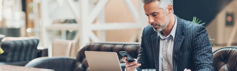 Man checking phone in airport