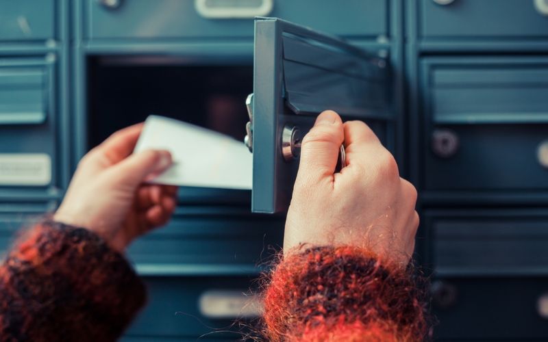 woman's hand as she is getting her post out of her letterbox