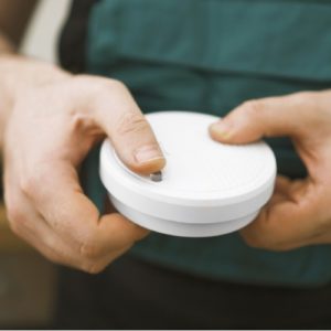 man holding smoke detector