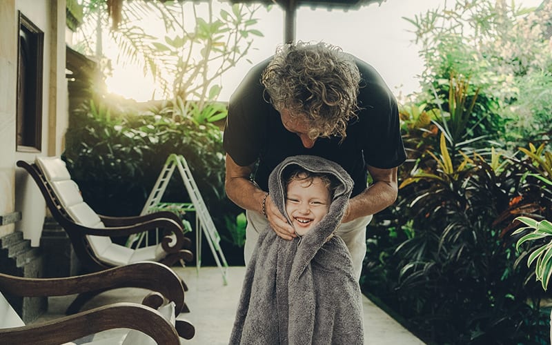 dad drying daughter off after swimming