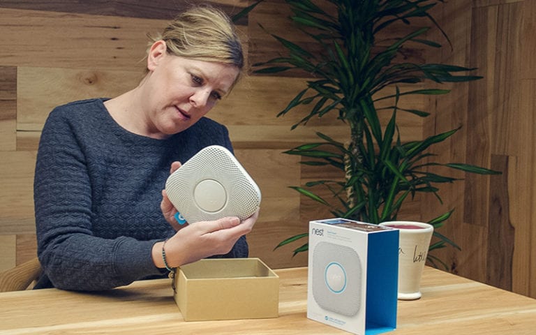 photo of person testing Nest Smoke Alarm