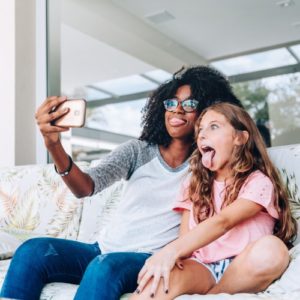 babysitter and girl take selfie