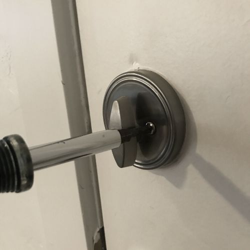 uninstalling a deadbolt with a screwdriver