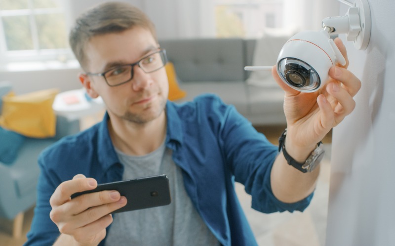 man adjusting security camera