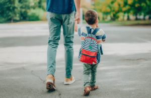 father walking kid to school